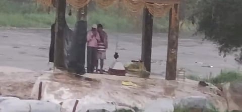 The sudden rains trapped two persons on a rock in the Musi at Chaitanyapuri 
