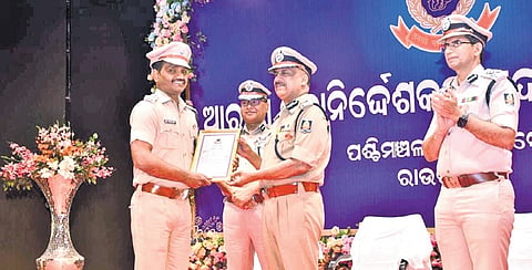 The DGP awarding a policeman in recognition of his service on Friday 