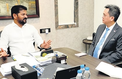 Chief Minister A Revanth Reddy speaks to Singapore Consul-General Edgar Pong at his residence in Hyderabad on Monday.