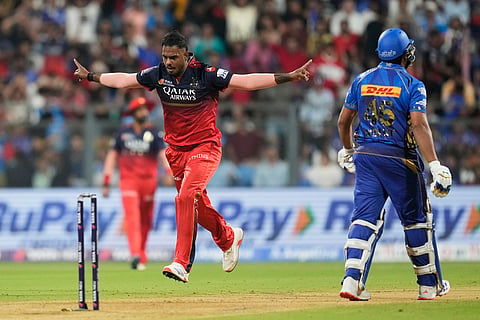 Royal Challengers Bengaluru's Yash Dayal, left, celebrates the dismissal of Mumbai Indians' Rohit Sharma (Photo | AP)