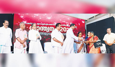 Archbishop Mar Thomas Tharayil of Syro-Malabar archdiocese of Changanassery presenting the keys to beneficiaries of the houses built by Dr George Peediyekkal and wife Dr Leelamma George at a function held on Saturday