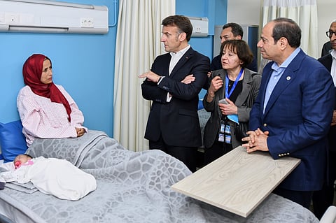 Egyptian President Abdel-Fattah el-Sissi, and his French counterpart Emmanuel Macron, visit a Palestinian patient l at a ward for Palestinian patients at El Arish Hospital, in the north of the Sinai peninsula, about 50 KM (32 miles) west of the border with the Gaza Strip