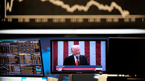 US President Donald Trump appears on a television screen at the stock market in Frankfurt, Germany, Thursday, April 3, 2025. 