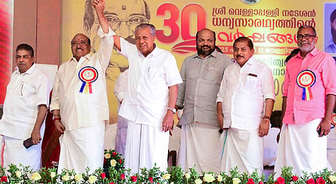 Chief Minister Pinarayi Vijayan holds up SNDP Yogam general secretary Vellappally Natesan’s hand at a public meeting in Cherthala on Friday.
