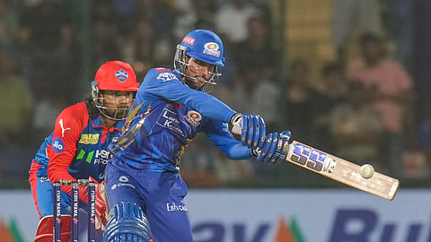 Mumbai Indians' Tilak Varma plays a shot during an Indian Premier League (IPL) 2025 T20 cricket match between Delhi Capitals and Mumbai Indians, at the Arun Jaitley Stadium, in New Delhi, Sunday, April 13, 2025. 