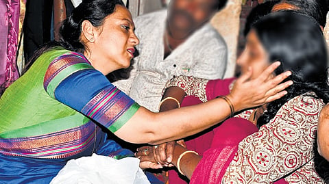Nagalakshmi Choudhary, president of the Karnataka State Women’s Commission,   consoles the mother of the minor girl, in Hubballi on Monday.