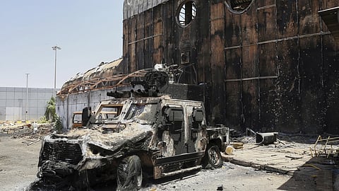 A burned military vehicle sits at Khartoum International Airport a day after it was recaptured from the paramilitary Rapid Support Forces (RSF) in Khartoum, Sudan, Thursday, March 27, 2025. 