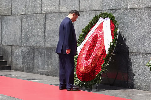 Chinese President Xi Jinping looks at a wreath at the Ho Chi Minh Mausoleum during his visit to Hanoi, Vietnam, Tuesday, April 15, 2025. 