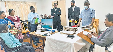 State Human Rights Commission member V Kannadasan presiding over a grievance redressal meet in Tirunelveli on Thursday.