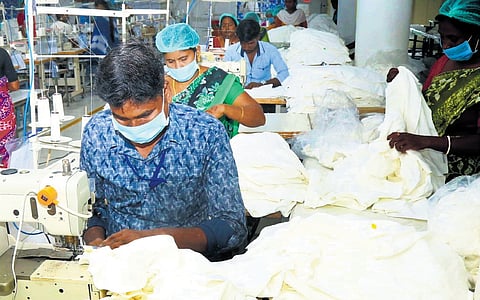Workers at a private knitwear company near Periyar Colony in Tiruppur 