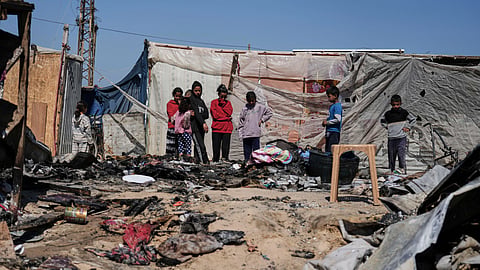 Palestinians inspect the remains of a displacement tent hit by an Israeli airstrike overnight, killing 10 members of the Abu Al-Rous family, in Khan Younis, southern Gaza Strip, Thursday, April 17, 2025. 