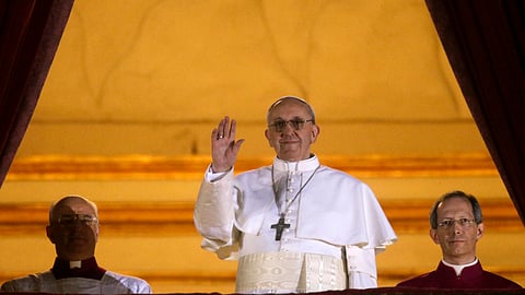 Then-Argentine Cardinal Jorge Bergoglio, who chose the name of Pope Francis, waves to the crowd from the central balcony of St. Peter's Basilica after being elected 266th pontiff of the Roman Catholic Church at the Vatican on Wednesday, March 13, 2013. 