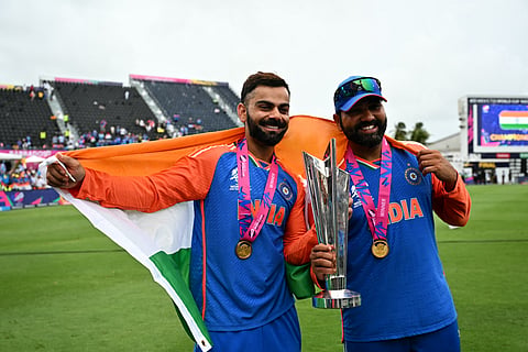 India's Virat Kohli and captain Rohit Sharma celebrate with the trophy after winning the ICC men's Twenty20 World Cup 2024 final cricket match between India and South Africa at Kensington Oval in Bridgetown, Barbados, on June 29, 2024. 