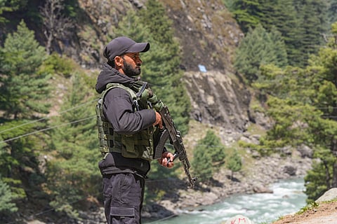 In this image from April 23, 2025, a security personnel keeps vigil, a day after a terrorist attack in Pahalgam, J & K. 