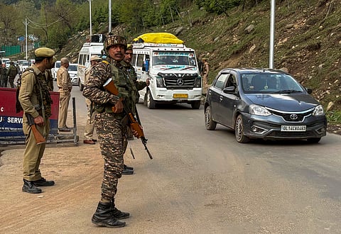  Security personnel stand guard after terrorists attacked a group of tourists at Pahalgam, in Anantnag district, Jammu & Kashmir, Tuesday, April 22, 2025. At least 12 people suffered injuries in the attack, according to officials.