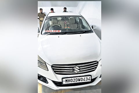 The car bearing a police board and 
a CBI sticker on its windshield