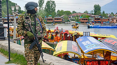 A security official keeps a vigil on the banks of Dal Lake, in the wake of the recent Pahalgam terrorist attack, in Srinagar, Jammu and Kashmir, Saturday, April 26, 2025.