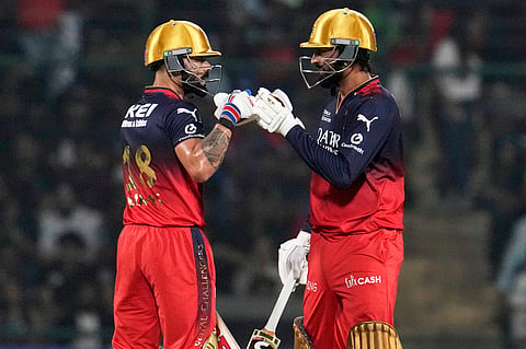 Royal Challengers Bengaluru's Virat Kohli, left, and batting partner Krunal Pandya touch gloves during the Indian Premier League cricket match between Delhi Capitals and Royal Challengers Bengaluru at Arun Jaitley Stadium in New Delhi, India, Monday, April 28, 2025.