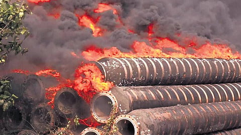 Pipes engulfed in flames at the open scrap yard outside Indian Oil premises 