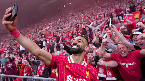 Liverpool's Mohamed Salah celebrates by taking a selfie after winning the EPL soccer match between Liverpool and Tottenham Hotspur and clinching the Premier League title at Anfield in Liverpool, England, Sunday, April 27, 2025.