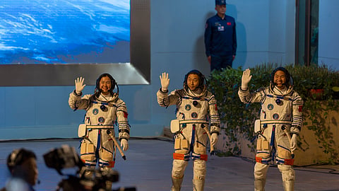Chinese astronauts Wang Haoze, from left, Cai Xuzhe and Song Lingdong wave as they attend the see-off ceremony for the Shenzhou-19 mission at the Jiuquan Satellite Launch Center in northwestern China, in the early hours of Oct. 30, 2024. 