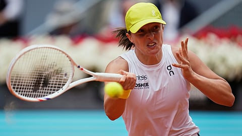 Iga Swiatek of Poland returns the ball against United States' Madison Keys during the Madrid Open tennis tournament in Madrid, Spain, Wednesday, April 30, 2025. 