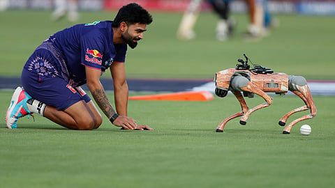 Rajasthan Royals' Kumar Kartikeya plays with the robot dog named Champak 