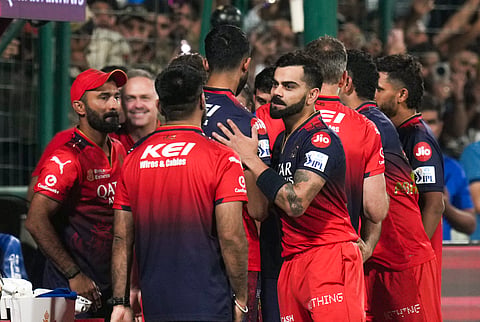 Royal Challengers Bengaluru's Virat Kohli and others celebrate in the dugout after RCB won the Indian Premier League (IPL) 2025 T20 cricket match against Delhi Capitals, at the Arun Jaitley Stadium, in New Delhi, Sunday, April 27, 2025.
