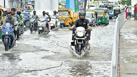 A  waterlogged road after sudden downpour at PNBS in Vijayawada on Sunday. 
