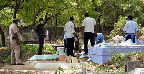 Police and medical team exhumed the body of Sigamani, a tour operator from Dubai for Post-mortem at Balammalpuram graveyard in Karur on Saturday: