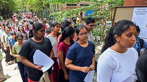 Aspirants wait to appear for the NEET UG exam, in Bengaluru.