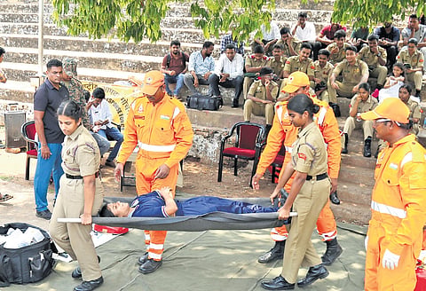 Civil Defence personnel carry out a mock drill demonstrating emergency response measures and rescue operations which aimed to create awareness among the public and assess preparedness in the event of disasters or emergency situations after Sindoor Operations in Visakhapatnam/Bapatla on Wednesday