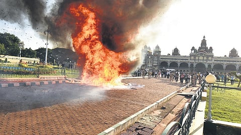 A fire rages on the Mysuru Palace grounds (left), as part of a civil defence mock drill under ‘Operation Abhyas’, as security personnel keep vigil on Saturday 