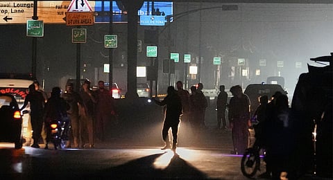 Police officers remove vehicles and people from the main entry of Nur Khan airbase following Indian missile strike on airbase, in Rawalpindi, Pakistan, Saturday, May 10, 2025. 