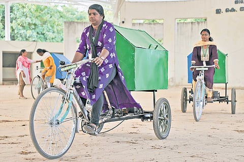 Haritha Karma Sena members being trained to ride the electric tricycle at E K Nayanar Park in Thiruvananthapuram on Monday. The electric tricycle is being given for smooth waste management in the city 