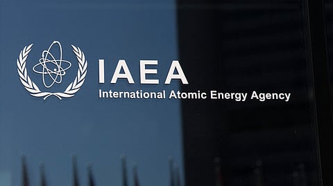 The logo of the International Atomic Energy Agency (IAEA) is pictured on a glassdoor in the IAEA building at the agency's headquarters in Vienna, Austria.
