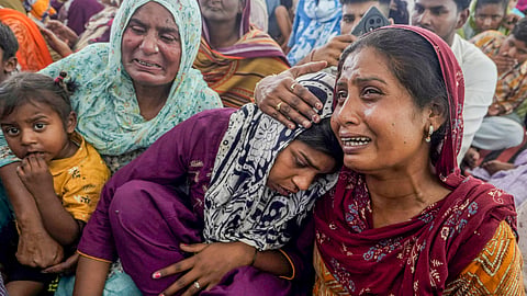  Relatives of the hooch tragedy victims mourn as they gather at a gurudwara to meet Punjab CM Bhagwant Mann, at Marari Kalan village, in Amritsar district, Tuesday, May 13, 2025.