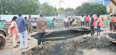 Metro workers and civic officials assessing and repairing the road that caved in near the Thiruvanmiyur signal on Saturday 