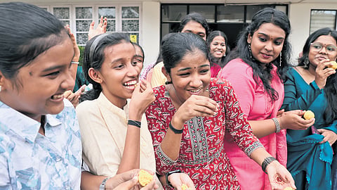 Students of Carmel Girls HSS, Thiruvananthapuram, share sweets in celebration after the announcement of their Plus-II examination results on Thursday 