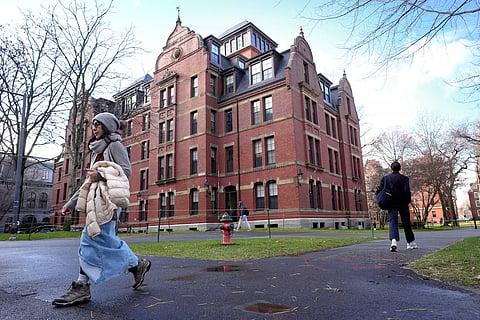 People walk between buildings, Dec. 17, 2024, on the campus of Harvard University in Cambridge, Mass. 