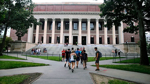 Students walk near the Widener Library in Harvard Yard at Harvard University in Cambridge.
