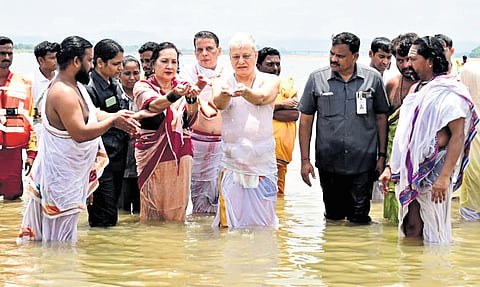 Governor Jishnu Dev Varma takes a holy dip in the Triveni Sangam on Sunday