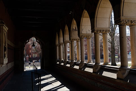 A person walks past Annenberg Hall at Harvard University on April 17, 2025 in Cambridge, Massachusetts. 