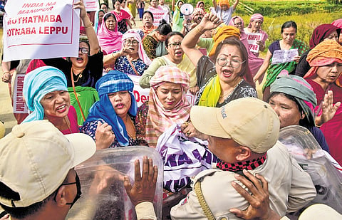 Security personnel stop agitators from reaching the DC office in Imphal East.