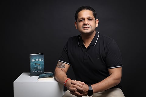 Author Pralav Dhyani with his book Hijacked 