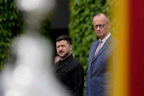 Germany's Chancellor Friedrich Merz, right, welcomes Ukraine's President Volodymyr Zelenskyy during an official military reception at the chancellery in Berlin, Germany, Wednesday, May 28, 2025.
