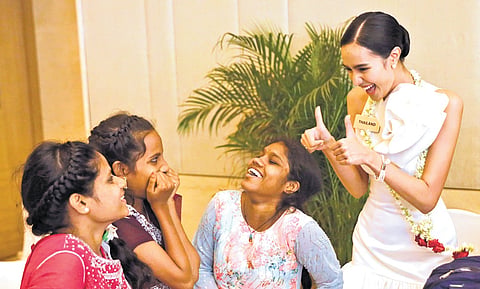A Miss World contestant interacts with visually impaired girls and orphans during a charity event held in Hyderabad on Wednesday 
