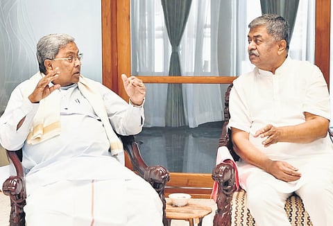 Chief Minister Siddaramaiah in conversation with Legislative Council member 
BK Hariprasad in Bengaluru on Thursday.