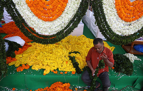 A worker is arranging flowers to decorate the stage area ahead of the Telangana Formation Day celebrations at the Parade Ground. 
