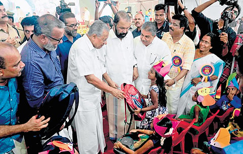 Chief Minister Pinarayi Vijayan handing over a school bag to a girl before the inauguration of state-level Praveshanotsavam at Government Higher Secondary School in Kalavoor, Alappuzha, on Monday 